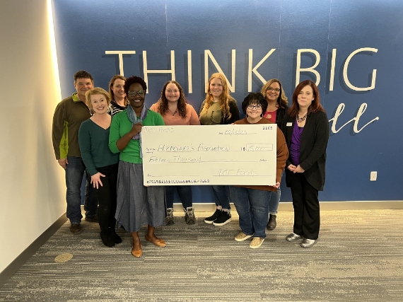 employees giving big check for charity
